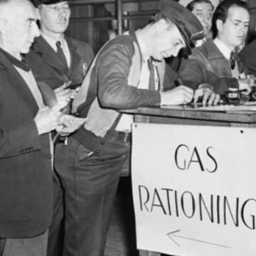 Men line up to sign in for rationed gasoline during 1942.