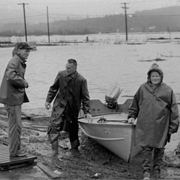 People leave a boat during massive flooding on the north coast of California in 1964.